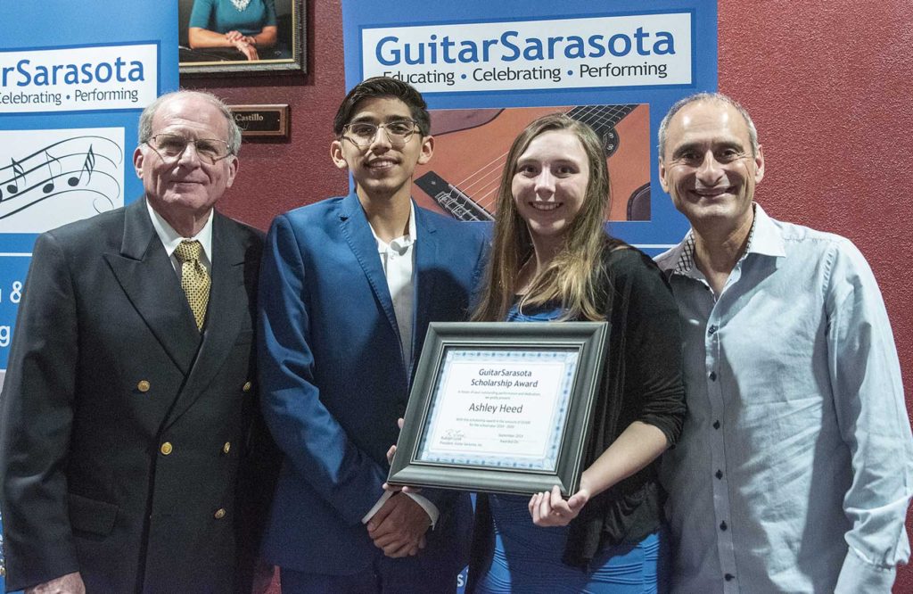 Guitar Sarasota President Rudolph Lucek (left) and Guitar Sarasota Vice President Frank Fernandez (right) presented scholarships to two State College of Florida students Isaiah Gomez and Ashley Heed.